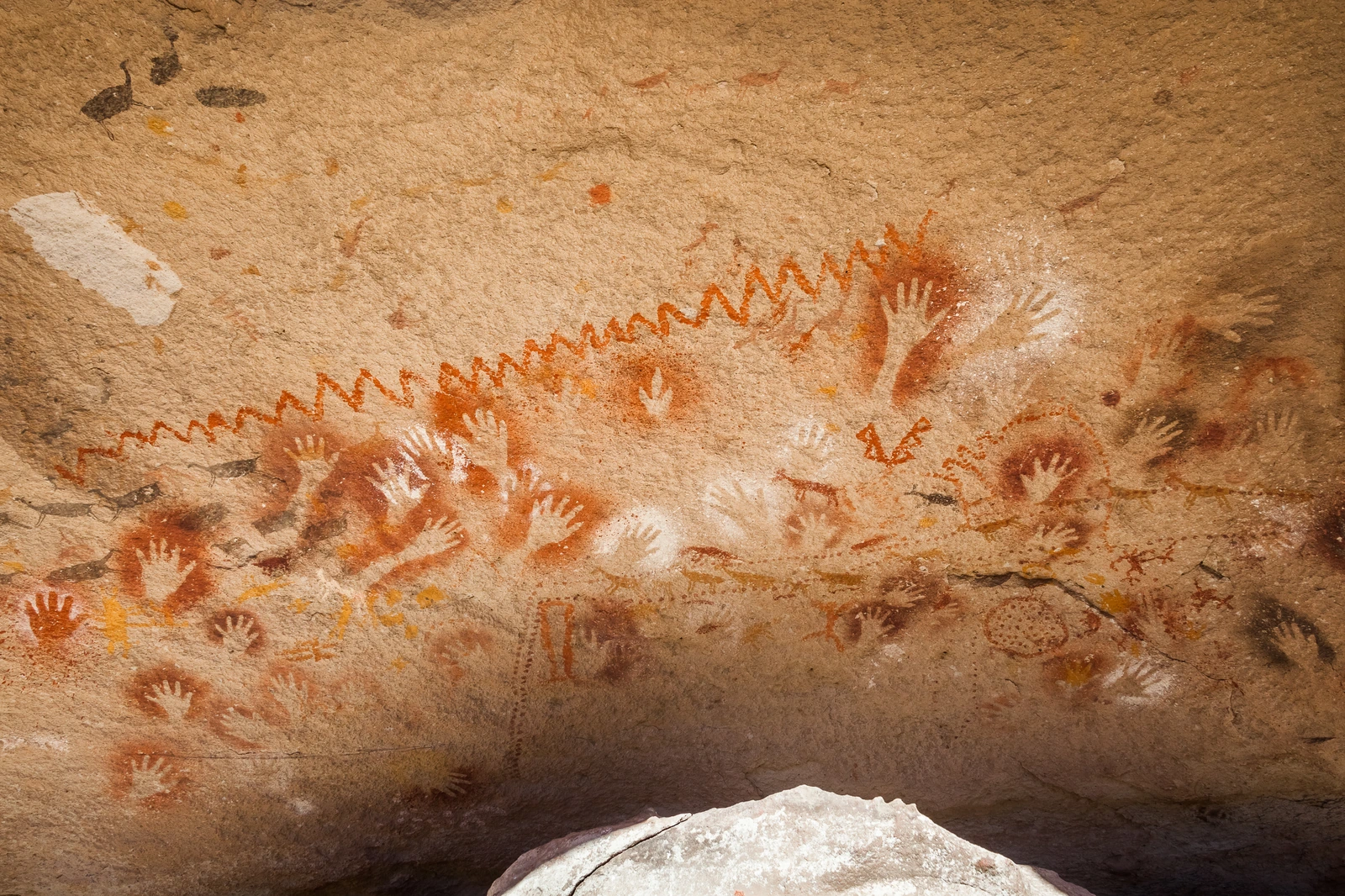 Arte rupestre con manos y motivos de distintos colores en Cueva de las Manos